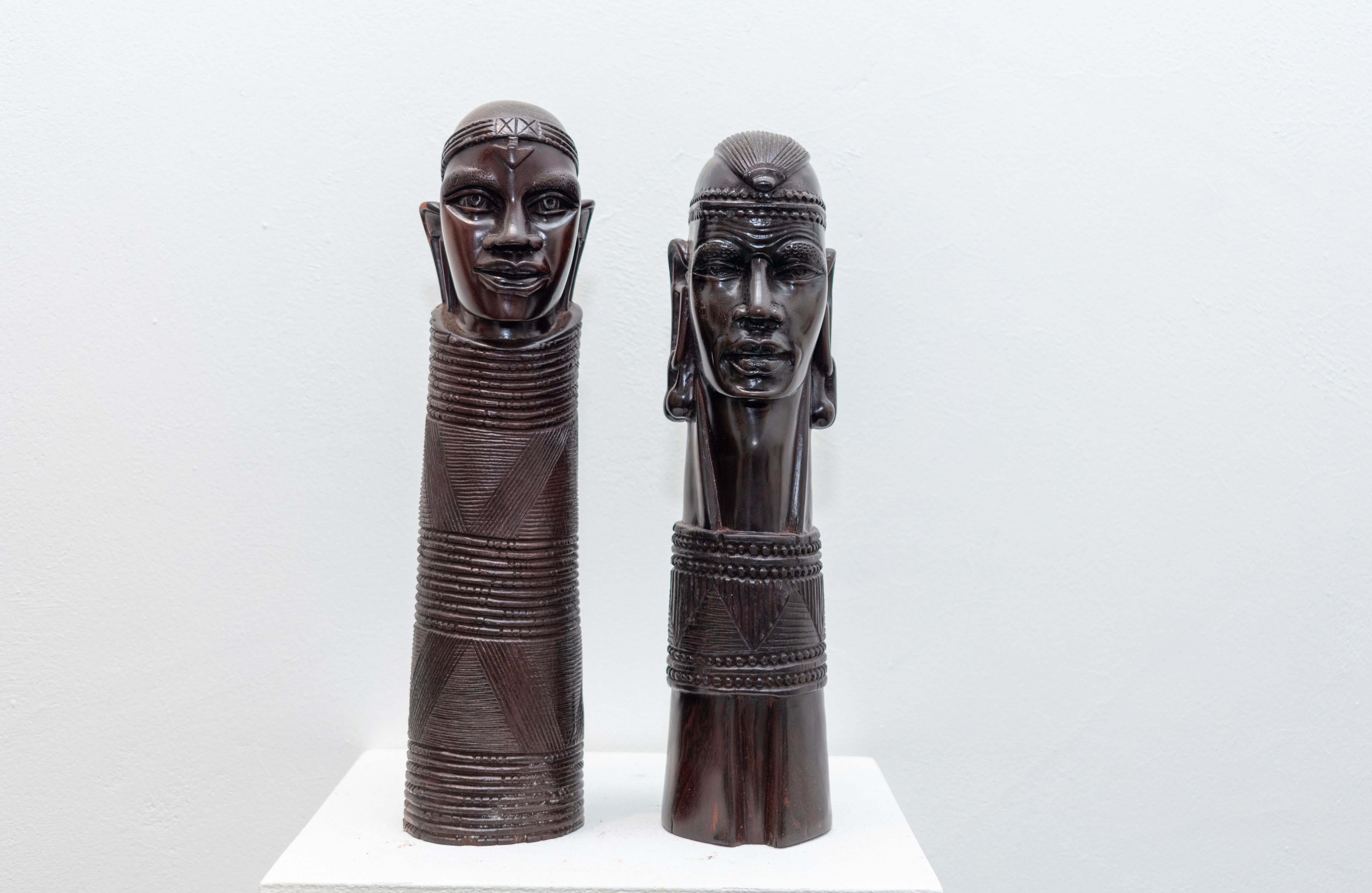 Pair of contemporary carved wooden African sculptures representing the Modern Gallery